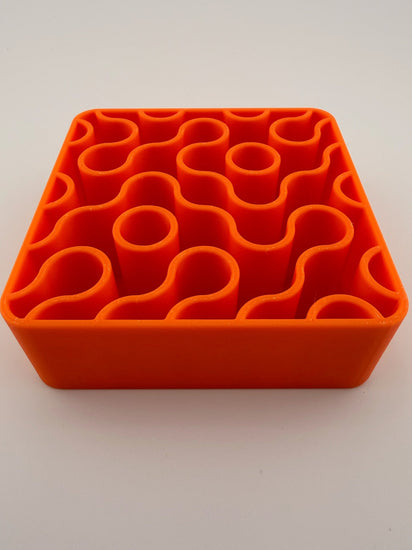 FIZZ tangerine holder with pens and brushes standing in it
