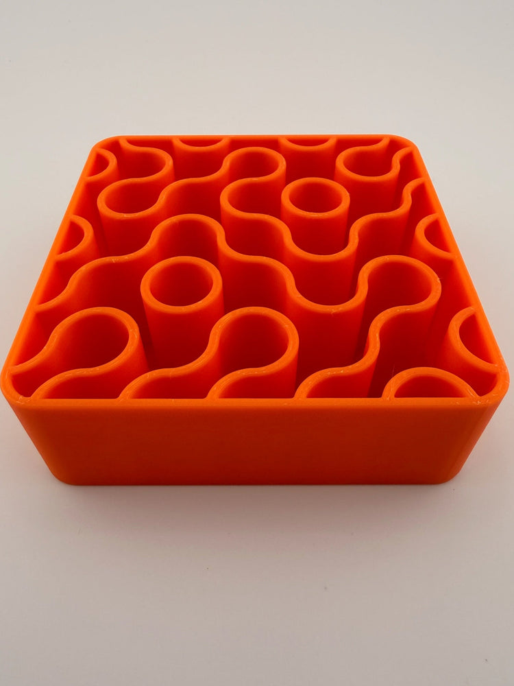 FIZZ tangerine holder with pens and brushes standing in it