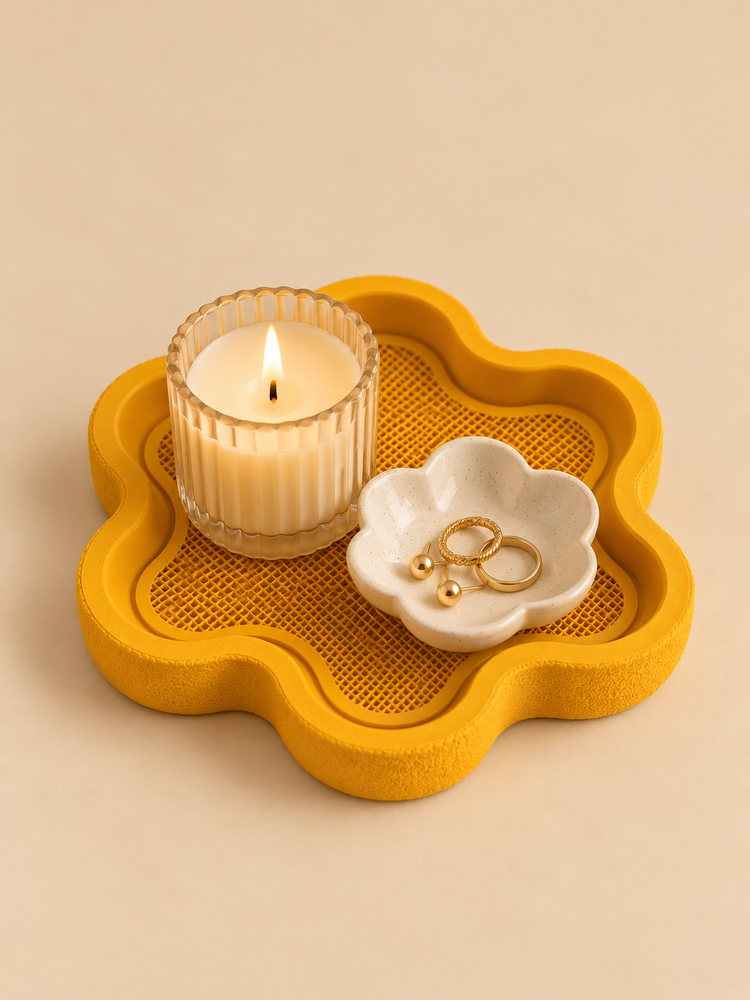 FLORA flower-shaped tray in honey amber on a nightstand