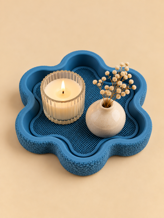 FLORA flower-shaped tray in denim blue on a nightstand