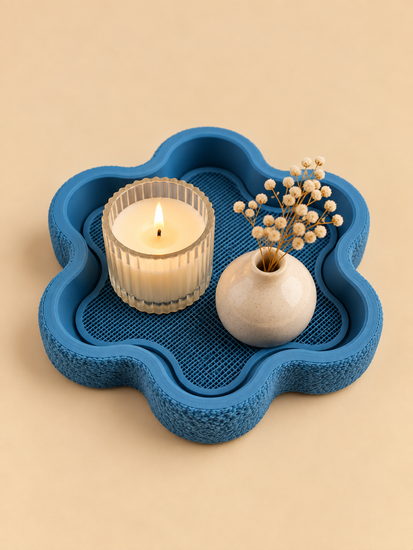 FLORA flower-shaped tray in denim blue on a nightstand